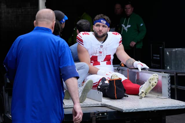 The running back grabbed a touchdown in the first quarter but was carried off in some distress in the second.