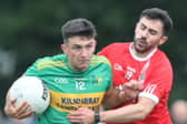Ruari McNamee is tackled by Mark Abbott. Picture: Ger Rogers