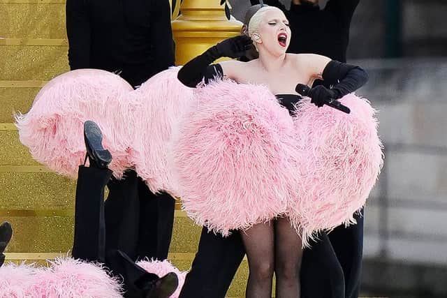 The five-time Grammy winner also posted images of her making a heart sign, wearing the same beaded silver gown with a high neckline that she wore during her performance, with an image of fans carrying a flag, made in the Olympics-style with the “o” in her name written using the games’ rings.
