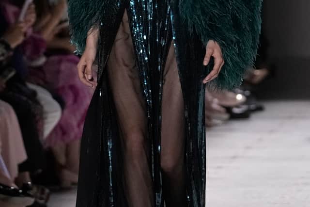 Whilst employing mystic motifs, the collection revelled in fabrics of crushed velvet, mesh and lace in a red wine and pitch palette. Saab – never one to bypass on glamour – layered the looks in shimmering fringe split skirts, dripping beads and cascading mesh.