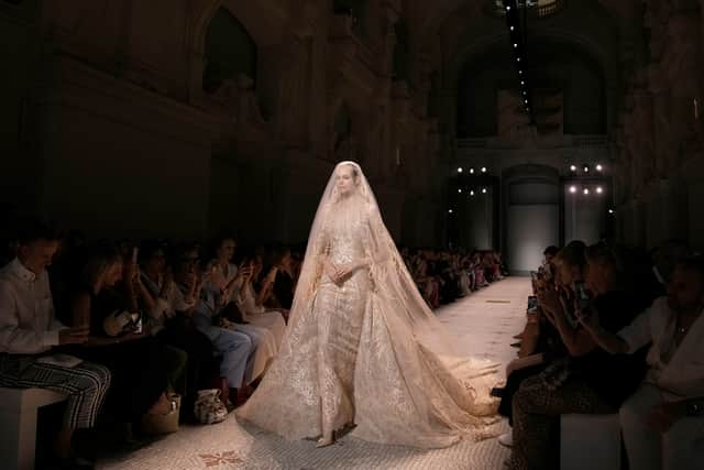 Encrusted bodices, sculpted silhouettes and fluid trains elevated the looks from Victoriana drama to fantastically feminine. Saab also married jewels to florals, creating an array of dazzlingly breath-taking prints.