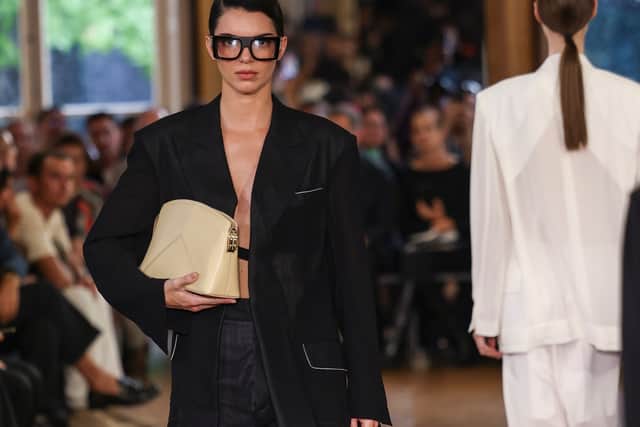 The model and reality star, 27, wore large glasses and carried a cream leather clutch bag.