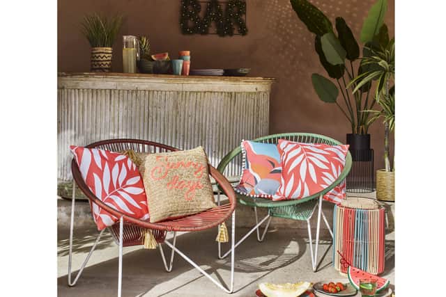 6. Natural Slogan Straw Effect Outdoor Cushion, £14; Orange Reversible Outdoor Cushion, £14, right; Orange Leaf Outdoor Cushion, £10, far left and far right; Multicoloured String Lantern, £25, Matalan