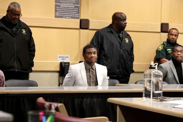 The defendants, two dressed in suits and one in a button-down shirt, showed little emotion as they stood one by one to be handcuffed by a bailiff.