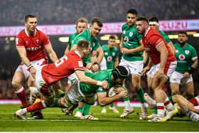 Caelan Doris of Ireland scores his side's first try despite the tackle of Liam Williams of Wales. (Picture: David Fitzgerald/Sportsfile)