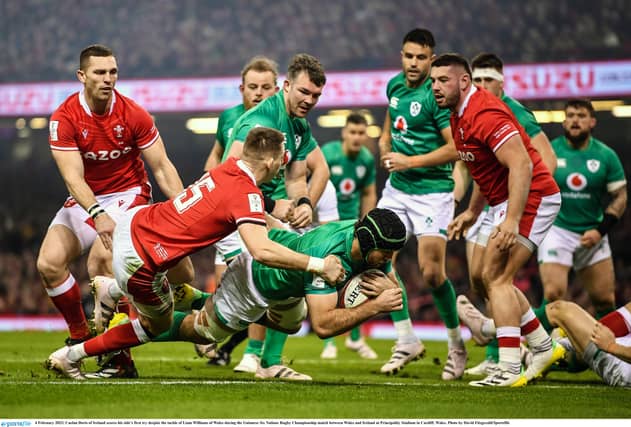 Caelan Doris of Ireland scores his side's first try despite the tackle of Liam Williams of Wales. (Picture: David Fitzgerald/Sportsfile)