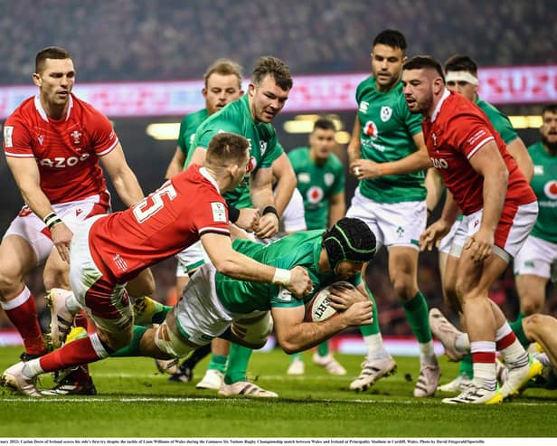 Caelan Doris of Ireland scores his side's first try despite the tackle of Liam Williams of Wales. (Picture: David Fitzgerald/Sportsfile)