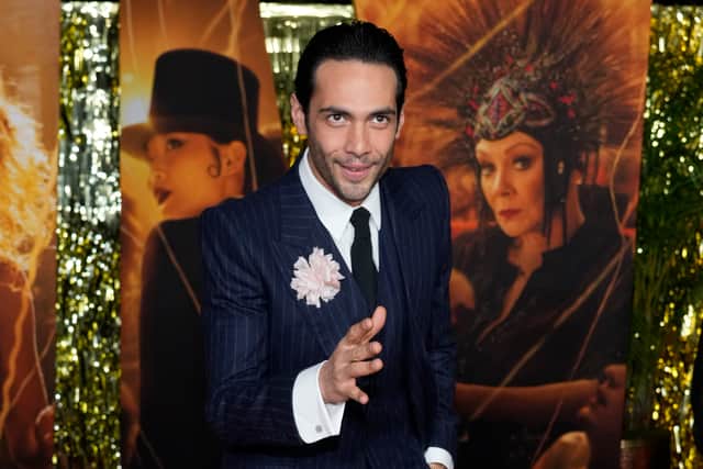 Calva wore an era-appropriate blue pinstripe three-piece suit, with a white shirt and tie, accessorising with a large pink flower.