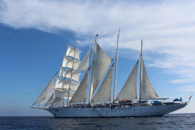 Armed with our cameras, we watch the extraordinary sight of the crew hoisting all 16 sails up the ship’s four masts. The wind by now is presenting ideal sailing conditions, the anchor comes up and she’s off, picking up speed and keeling gently into the wind.
