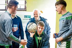 Darragh pictured in the team's dressing room with football board chairman Gerry Phillips, Monagea, Adare footballer Paul Maher and Colm McSweeney, Gerald Griffins