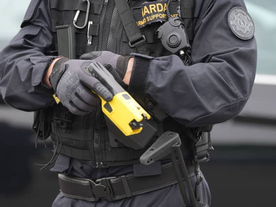 Garda member with Taser