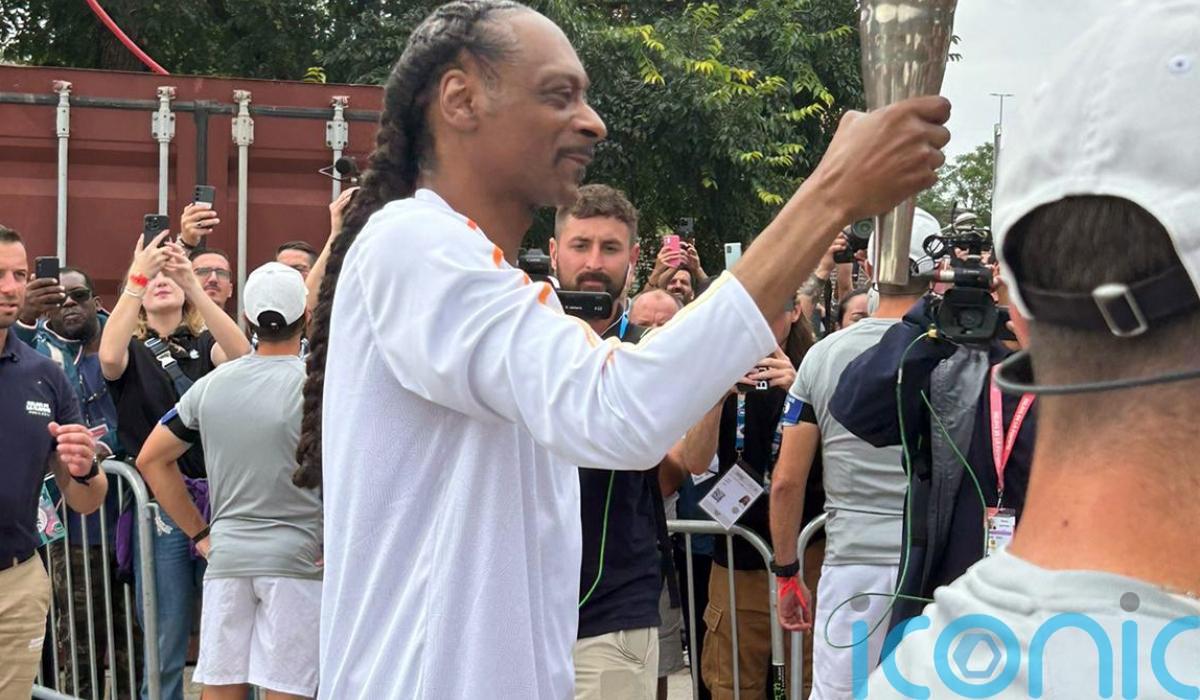 Crowds cheer as Snoop Dogg carries Olympic torch for Paris 2024 Games